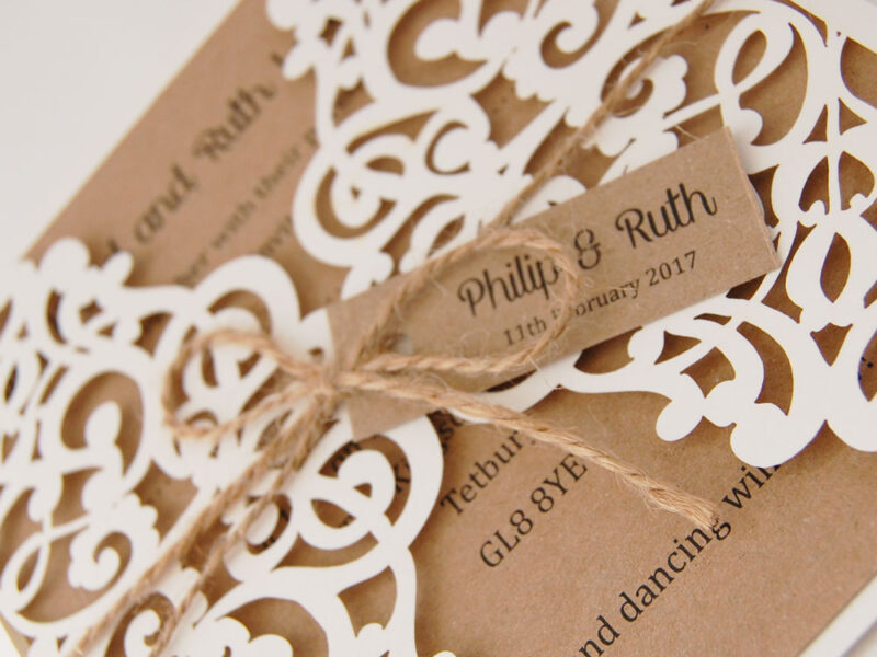 lace laser cut wedding invitation close up of cream laser cut and kraft card