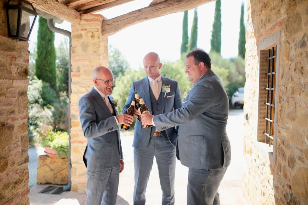 Groomsmen having a beer on wedding day