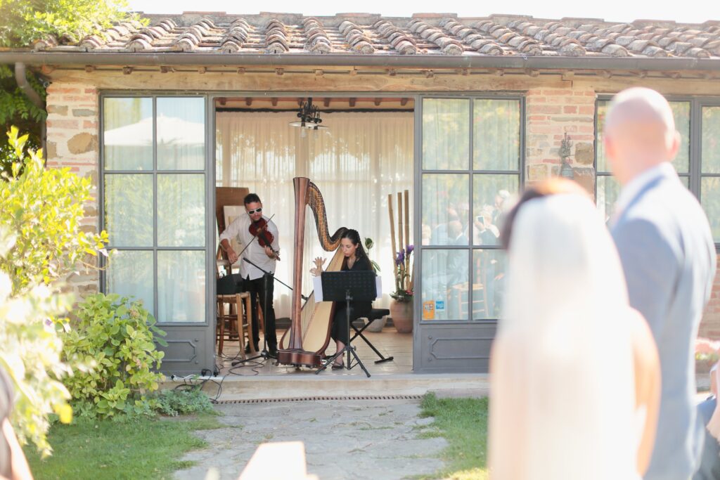 Harpist & violinist play at wedding