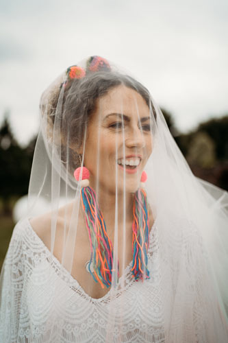 bohemian bride with viel and neon pom pom earings