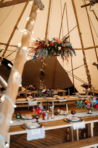 colourful wedding reception set up with floating flower display